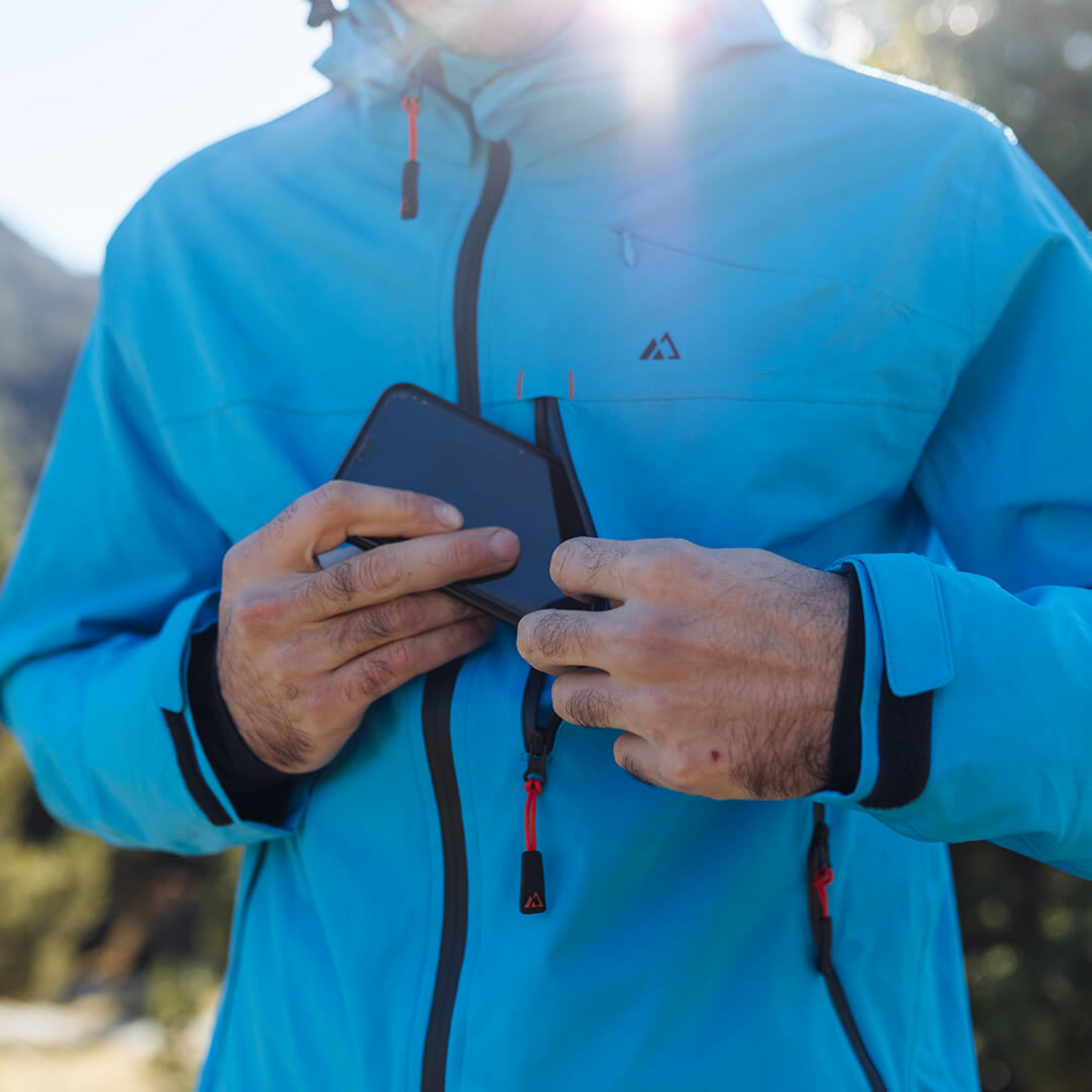 Men's Apricoat Adventurer 2.0 Weatherproof Rain Jacket in sky blue, featuring 16 integrated pockets, built-in gloves, and made from recycled materials.