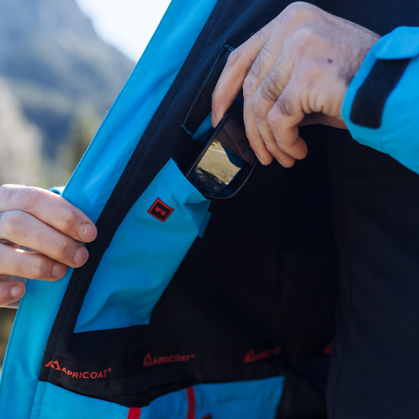 Men's Apricoat Adventurer 2.0 Weatherproof Rain Jacket in sky blue, featuring 16 integrated pockets, built-in gloves, and made from recycled materials.
