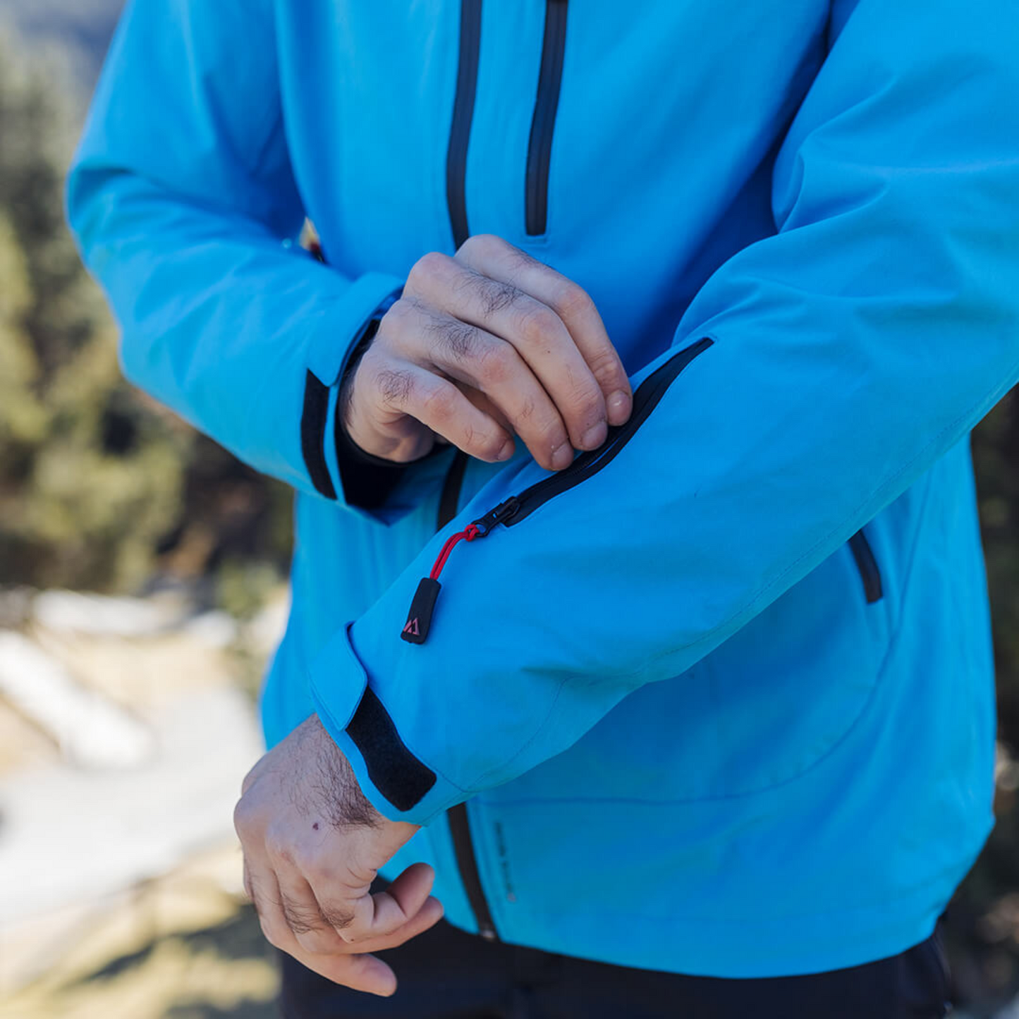 Men's Apricoat Adventurer 2.0 Weatherproof Rain Jacket in sky blue, featuring 16 integrated pockets, built-in gloves, and made from recycled materials.