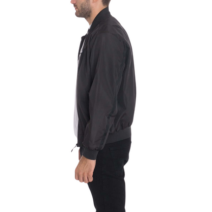 Men's black waterproof windbreaker jacket with full front zipper, ribbed cuffs, and multiple utility pockets.
