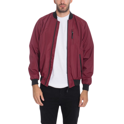 Men's burgundy waterproof windbreaker jacket with full front zipper, ribbed cuffs, and multiple utility pockets.