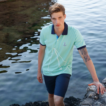 Men's Nautical Cotton Polo Shirt by Anemoss in mint green with black collar and sleeve trim, featuring an embroidered anchor logo on the chest and a large sailboat graphic across the fron
