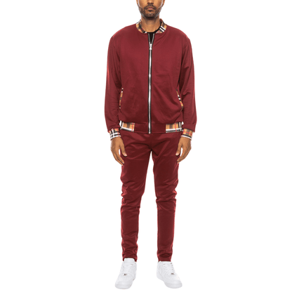 Men's two-piece Version Couture track suit with zip-up jacket and matching pants, featuring checkered detail on the collar, cuffs, and waistband.