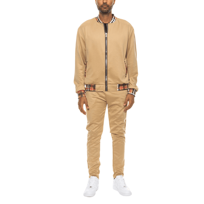 Men's two-piece Version Couture track suit with zip-up jacket and matching pants, featuring checkered detail on the collar, cuffs, and waistband.