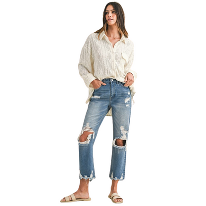 Women's Distressed Denim Cropped and Whiskered Jeans by Annie with raw hem and vintage detailing for a stylish, casual look. Available in sizes Small to Extra Large